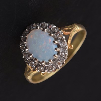 Lot 32 - Opal and diamond 18ct gold cluster ring