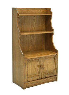 Lot 681 - Ercol Windsor elm waterfall cupboard and shelves