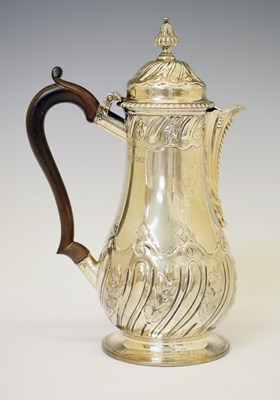 Lot 264 - George V silver hot water jug with embossed decoration