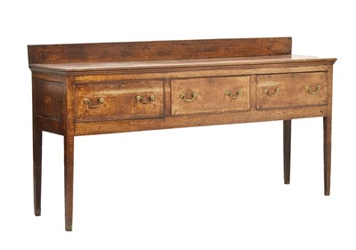 Lot 552 - George III oak and crossbanded three-drawer dresser base