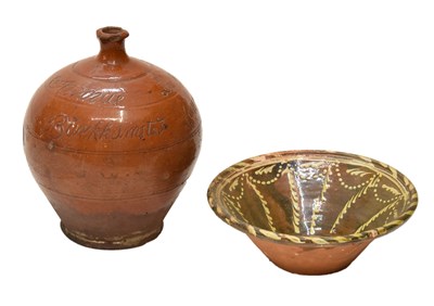 Lot 298 - Early 19th century terracotta flagon, and a slipware pottery bowl