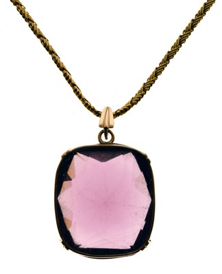 Lot 82 - Victorian yellow metal chain tagged '15' with large amethyst-coloured glass pendant