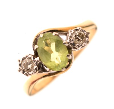 Lot 24 - Peridot and diamond three-stone ring