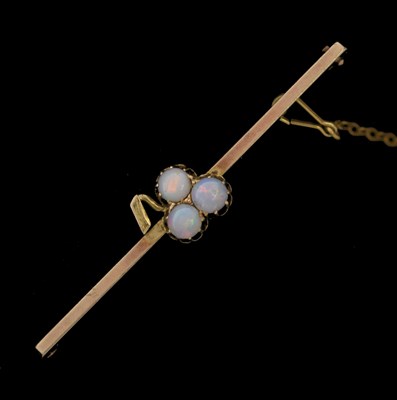 Lot 70 - Yellow metal bar brooch with trefoil of opals