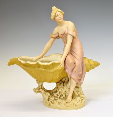 Lot 521 - Royal Dux - Porcelain figure of a maiden seated beside a large conch shell