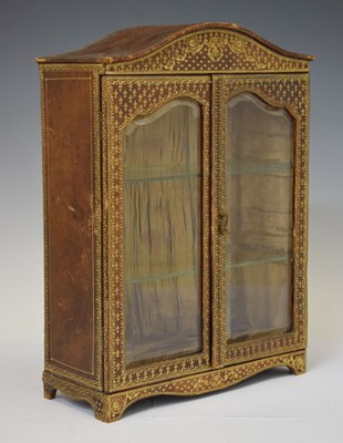 Lot 362 - Early 20th century gilt leather glazed table top cabinet