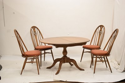 Lot 697 - Ercol - Set of four Windsor swan-back dining chairs and dining table