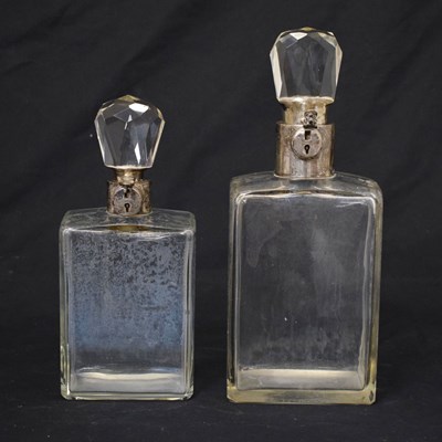 Lot 89 - Hukin & Heath Ltd. - Two George V silver-mounted lockable glass decanters