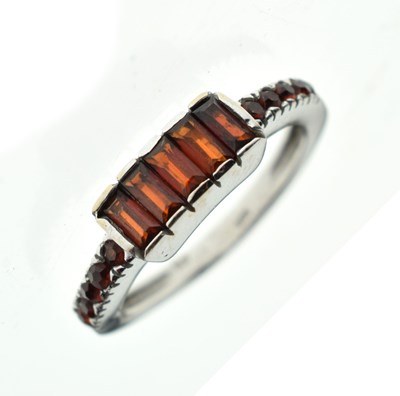 Lot 22 - White gold ring set five garnet-coloured baguette-cut stones