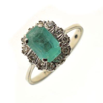 Lot 18 - 18ct white gold, emerald and diamond cluster ring