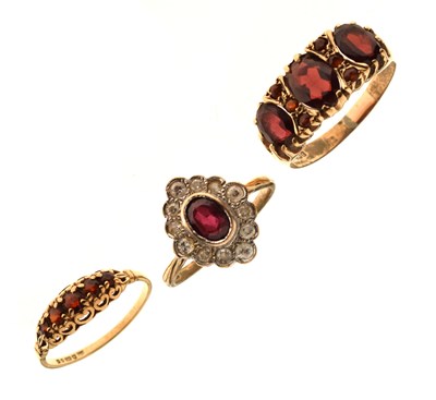 Lot 67 - Three 9ct gold garnet dress rings