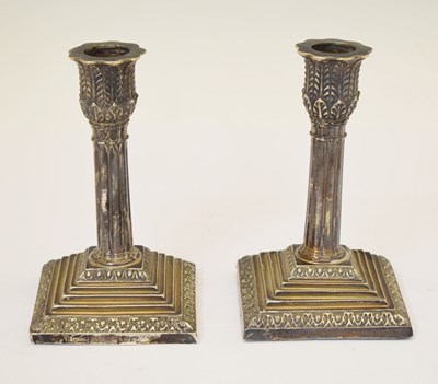 Lot 252 - Pair of Victorian silver dwarf Corinthian column candlesticks standing on a square base