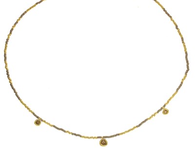 Lot 118 - Yellow and white 18ct gold beaded necklace