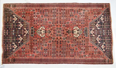 Lot 677 - Middle Eastern style red ground wool rug