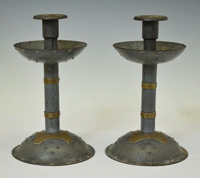 Lot 406 - Pair of early 20th century Arts & Crafts design brass mounted anodised metal candlesticks