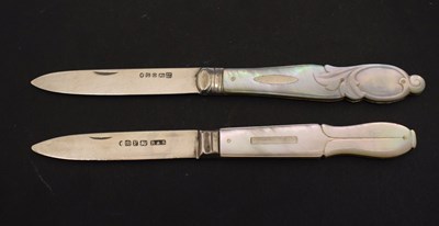 Lot 215 - Two Victorian mother-of-pearl mounted silver folding fruit knives