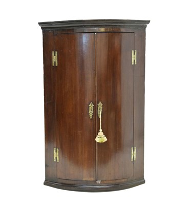 Lot 592 - George III mahogany bowfront hanging corner cupboard