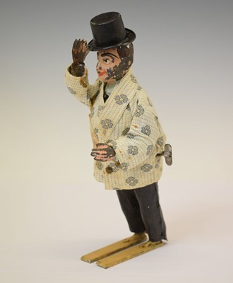 Lot 355 - Early 20th century tinplate clockwork automaton of a gentleman