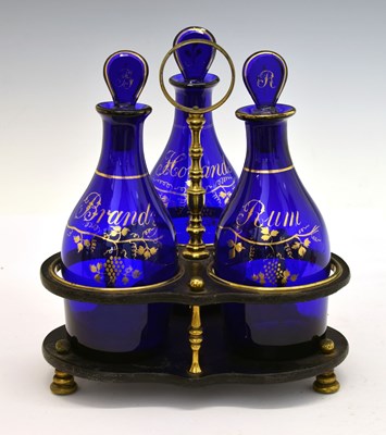 Lot 257 - Three-bottle decanter set and stand