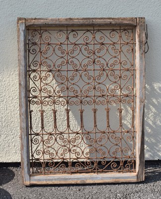 Lot 64 - Moroccan wrought iron and wood framed Riad window grille