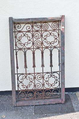 Lot 65 - Moroccan wrought iron and wood framed Riad window grille