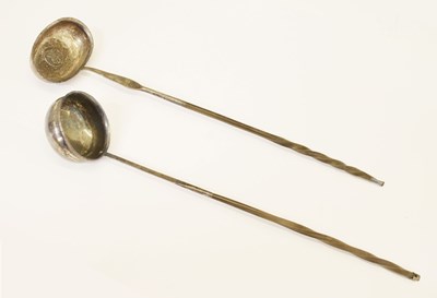 Lot 211 - 19th century white metal toddy ladle with twisted baleen handle, and a similar plated example