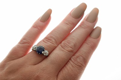 Lot 13 - Sapphire and diamond white metal three-stone ring