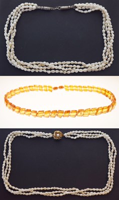 Lot 62 - Two freshwater rice pearl multi row necklaces, and a Baltic Amber necklace (3)