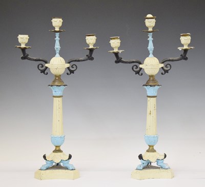 Lot 344 - Pair of cream and blue painted cast metal two-branch candelabra