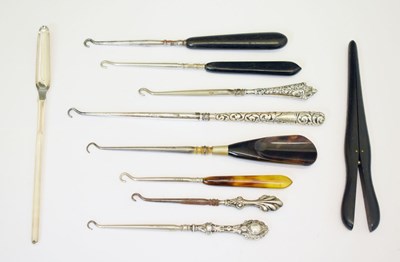 Lot 176 - Four silver-handled button hooks, silver-plated morrow spoon / scoop, etc