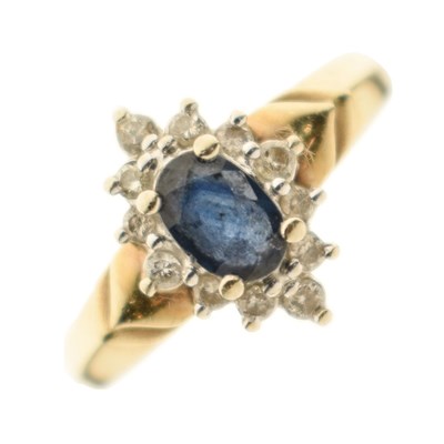 Lot 11 - Yellow metal (14Kt) sapphire and diamond cluster ring