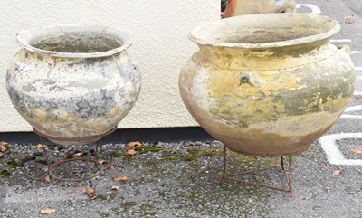 Lot 760 - Two large terracotta planters on metal stands