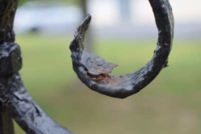 Lot 514 - Black painted wrought iron garden bench
