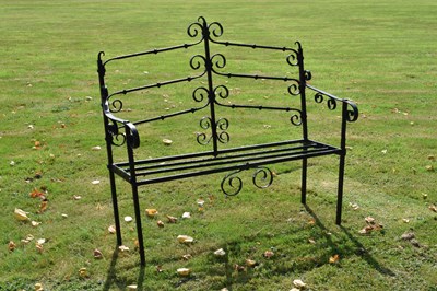 Lot 514 - Black painted wrought iron garden bench