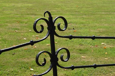 Lot 514 - Black painted wrought iron garden bench