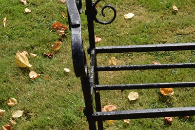 Lot 514 - Black painted wrought iron garden bench