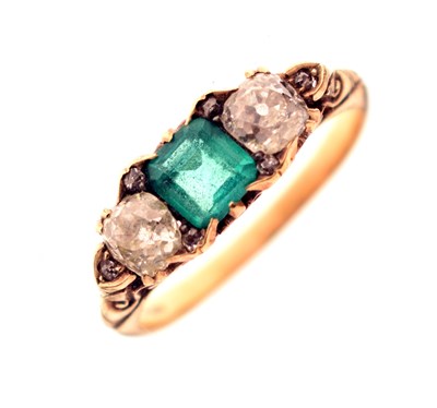 Lot 11 - Emerald and diamond three stone yellow metal ring