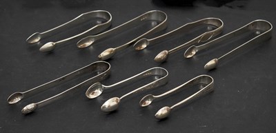 Lot 238 - Seven pairs of George III to Victorian silver sugar tongs, various Exeter makers