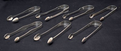 Lot 260 - Seven pairs of George III silver sugar tongs