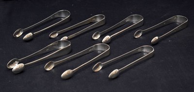 Lot 261 - Seven pairs of George III silver sugar tongs