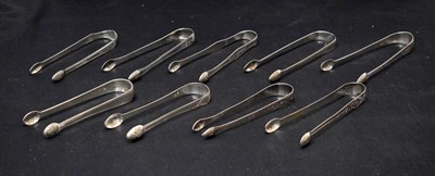 Lot 263 - Nine pairs of George III silver sugar tongs each with bright-cut decoration