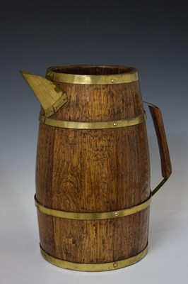 Lot 338 - Early 20th century coopered oak and gilt metal bound jug