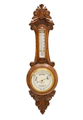 Lot 644 - Early 20th century carved oak aneroid barometer