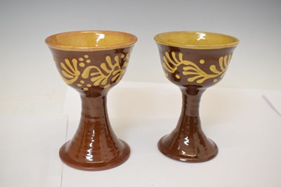 Lot 538 - Studio Pottery - Set of eight slip decorated terracotta goblets by Wetheriggs Pottery