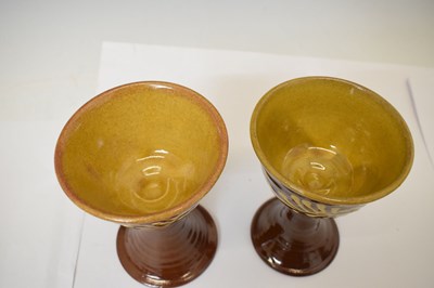 Lot 538 - Studio Pottery - Set of eight slip decorated terracotta goblets by Wetheriggs Pottery