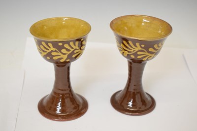 Lot 538 - Studio Pottery - Set of eight slip decorated terracotta goblets by Wetheriggs Pottery