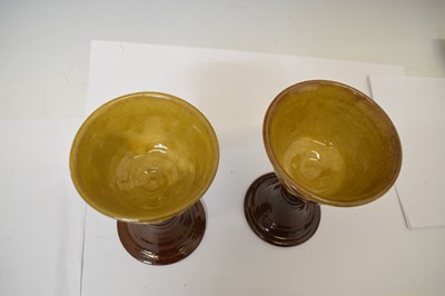 Lot 538 - Studio Pottery - Set of eight slip decorated terracotta goblets by Wetheriggs Pottery