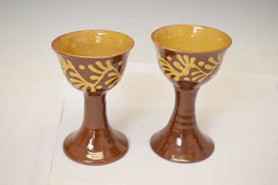 Lot 538 - Studio Pottery - Set of eight slip decorated terracotta goblets by Wetheriggs Pottery