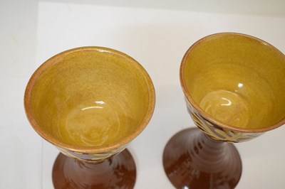 Lot 538 - Studio Pottery - Set of eight slip decorated terracotta goblets by Wetheriggs Pottery