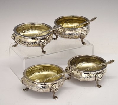 Lot Matched set of four silver salts each standing on three mask and paw feet